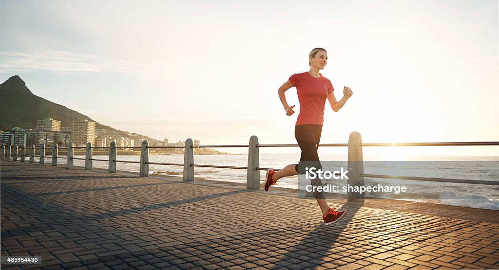 Run like you're on fire Shot of a young woman jogging on the promenadehttp://195.154.178.81/DATA/i_collage/pu/shoots/805460.jpg 20-29 Years Stock Photo