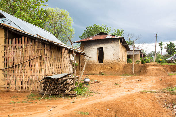 Rural setting with Mud Hut in village of Tripura, India. stock photo