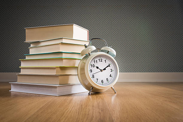 istock Pile of books with alarm clock 485954566