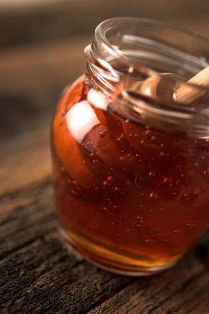 istock Jar of honey and honey dipper 485955024