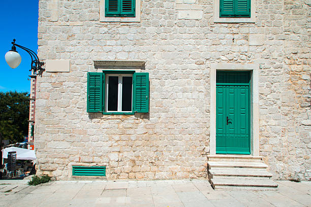     Windows and doors on old traditional house in Sibenik, Croatia, facade details 