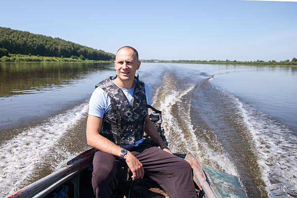 istock fisherman on boat rides in river 485957542
