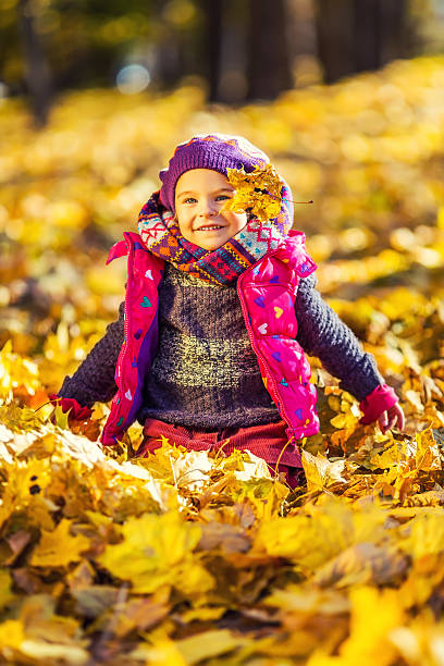 istock Little girl playing with autumn leaves 485959996