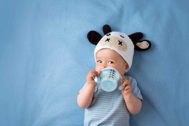 istock Baby in a cow hat drinking milk 485963006