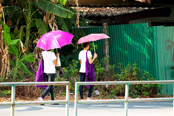 A digitally generated image featuring an umbrella with particles set against a vibrant neon lighting background, symbolizing protection, technology and futuristic aesthetics. This conceptual design represents security, digital transformation and innovation, making it ideal for cyber security, weather protection and abstract themes.