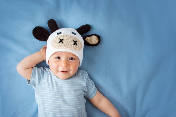 istock Baby in a cow hat on blue blanket 485964406