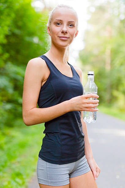 istock Smiling young woman having her break after running 485965318