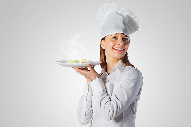 istock Happy cook woman holding a dish 485965895