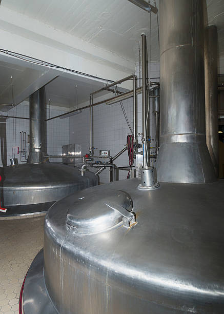 Rustproof brewing vessels. Rustproof brewing vessels at Van Honsebrouck brewery in Ingelmunster, Belgium, March 2014. Closest one is mash tun, and the other the boiling tun. Clean environment is key at modern breweries. Unsurprisingly, gray is the main color in this photo. rustproof stock pictures, royalty-free photos & images