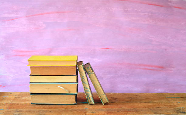 istock stack of books on purple background, free copy space 485968547