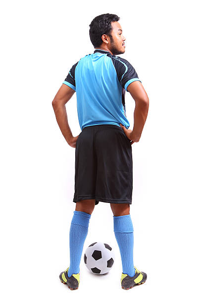 Young soccer football player on white