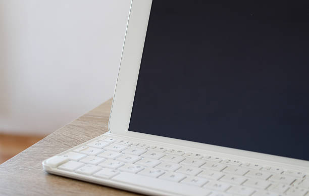 White tablet with keyboard on the table stock photo