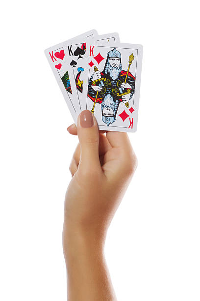 istock Playing cards in hand isolated on white background 485970334