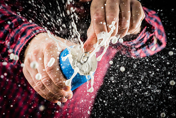 Frothy foam splashing out of a tin can Man opening a beer tin and frothy foam splashing out drink can photos stock pictures, royalty-free photos & images