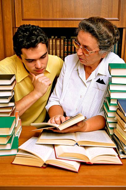 istock Student and teacher with lots of books 485972872