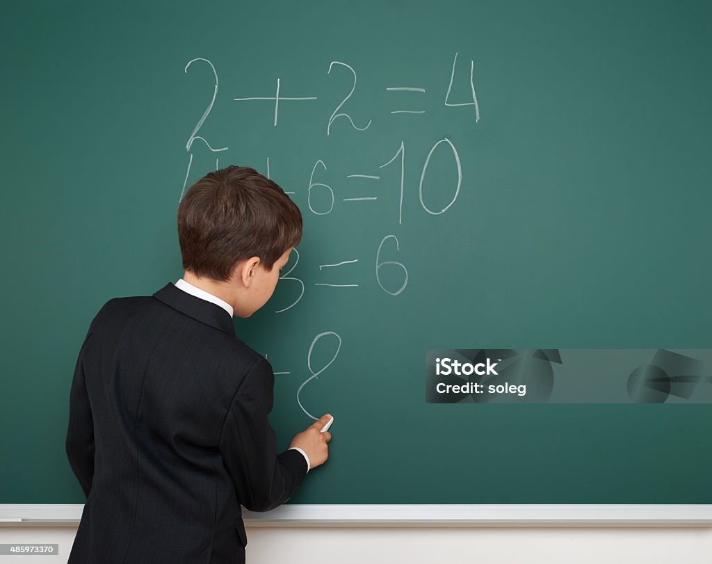 School boy solve math on school board School boy solve math on the school board 2015 Stock Photo