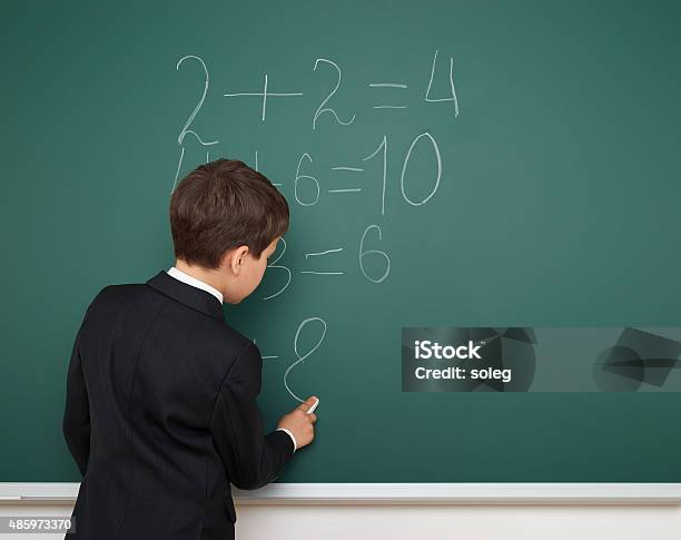 School Boy Solve Math On School Board Stock Photo - Download Image Now - 2015, Black Color, Boys