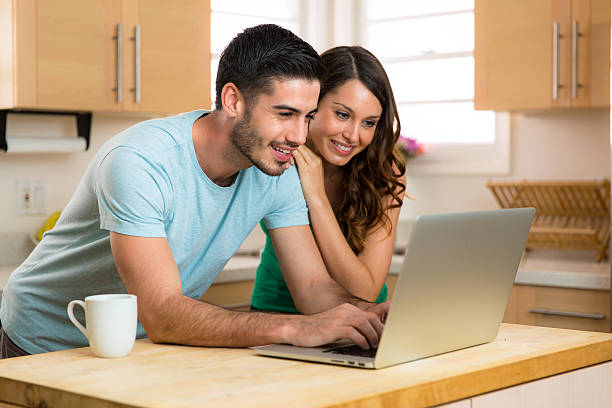 istock Husband wife married couple computer laptop laughing smiling funny content 485977124