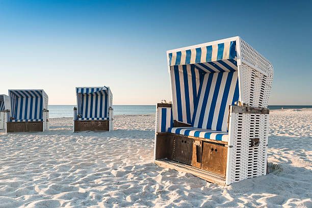Beach - chairs on the island Sylt on sunset. Germany. stock photo