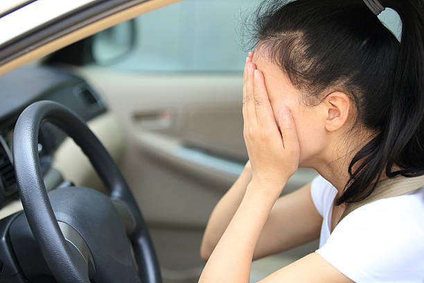 istock sad woman driver sit in car 485980239