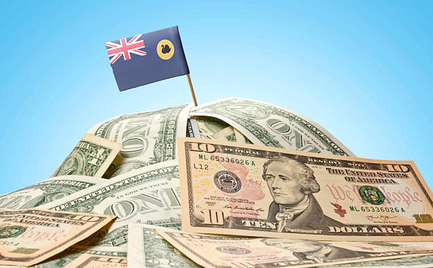 Flag of Western Australia sticking in american banknotes.(series The national flag of Western Australia sticking in a pile of american dollars.(series) Highest Paying Jobs in Australia stock pictures, royalty-free photos & images