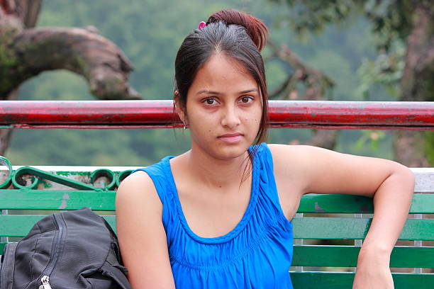Young Indian girl sitting on a bench in a hill station, Jammu and Kashmir, India.