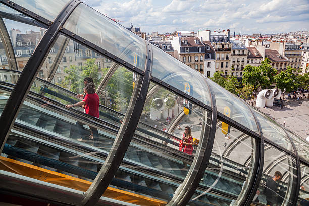 Paris, France - August 04, 2014: tunnel for exterior escalator at the Centre Pompidou with unidentified people. The building is in high-tech architectural style and houses a famous museum.