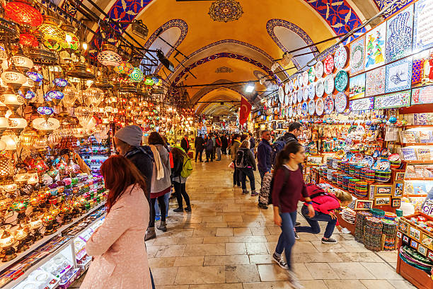 on the Grand Bazaar in Istanbul Istanbul, Turkey - April 10, 2015: Grand Bazaar in Istanbul with unidentified people. It is one of the largest and oldest covered markets in the world, with 61 covered streets and over 3,000 shops bazaar market stock pictures, royalty-free photos & images