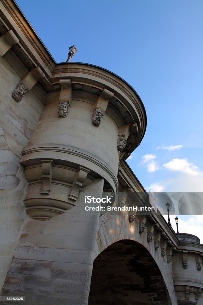 Oldest Bridge Pont Neuf over the Seine River in Paris, glowing in the evening Anthropomorphic Stock Photo