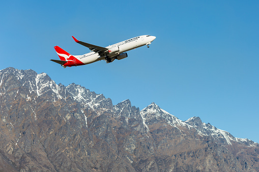 Queenstown, New Zealand - September 1, 2014: Qantas plane takes off in Queenstown International Airport on September 1, 2014 in Queenstown, New Zealand. Queenstown International Airport  has been voted the world's most scenic airport approach
