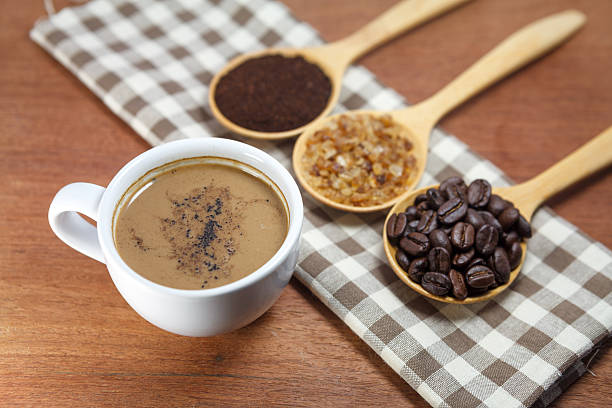 istock coffee beans and sugar in wooden spoon 485983435
