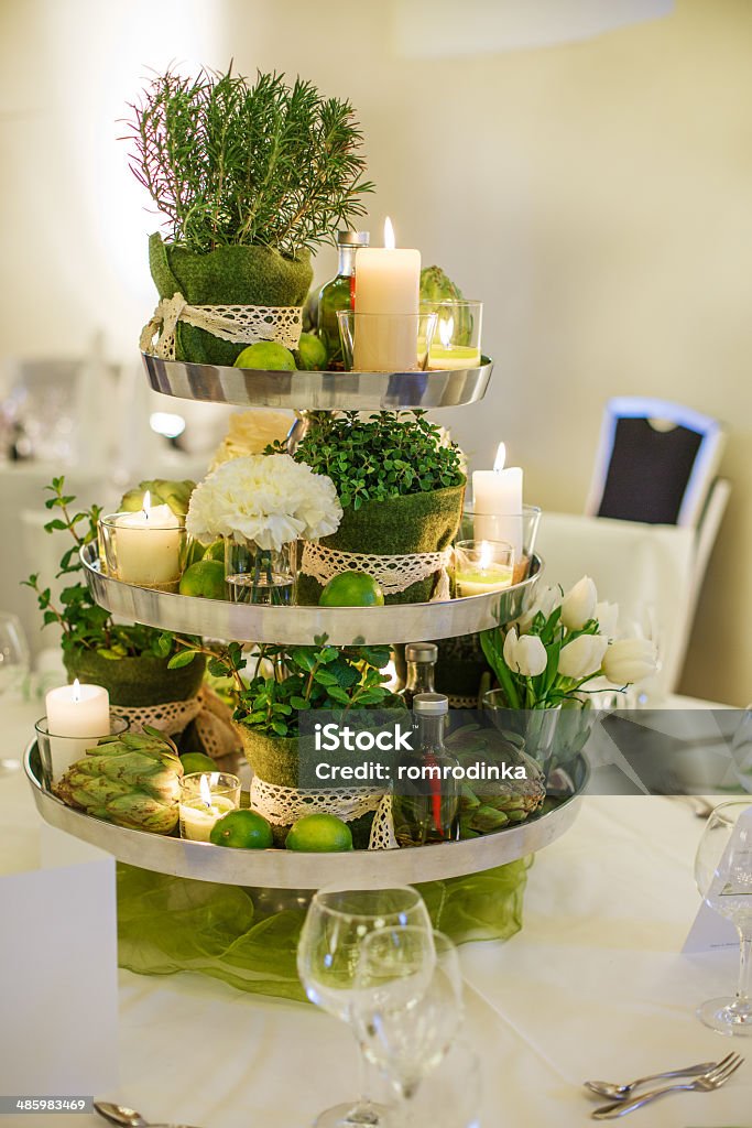 Elegant table set  for wedding or event party Beautiful table set  for green wedding or event party, indoors with big flower and candle arrangement Arrangement Stock Photo