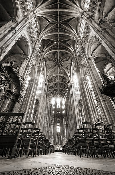 Nave with Vaulted Arches, Church of Saint Eustache, Paris, France Black & White interior photo of the nave, Church of Saint Eustache, Paris, France. Rows of wooden chairs lead to the alter. The church, in Les Halles, 1st arrondissement, is an example of French Gothic architecture with vaulted arches. église saint eustache stock pictures, royalty-free photos & images