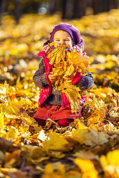 istock Little girl playing with autumn leaves 485989302