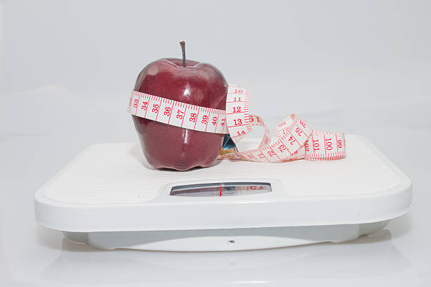 istock Red apple on the scales 485994388