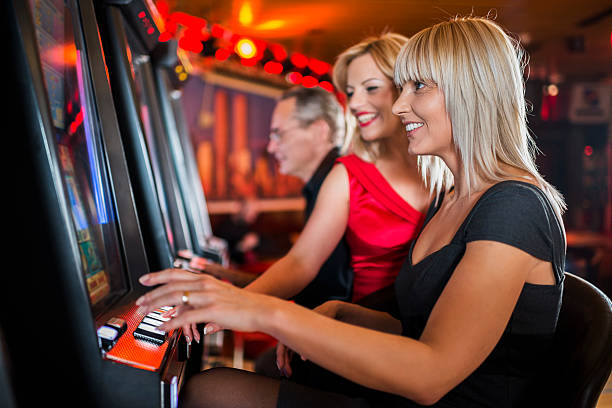 istock Happy people gambling on slot machines. 485997484