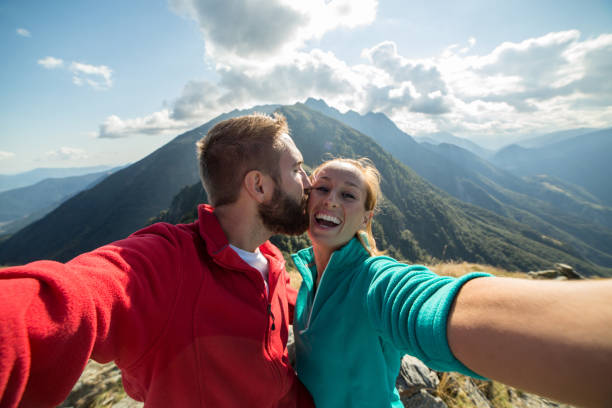 istock Couple at mountain top taking selfie 485997706