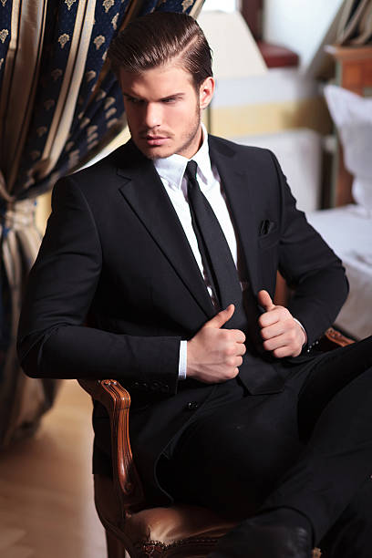 istock young business man on chair holds jacket 485998849