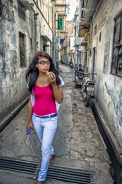 Young Indian women snacking on samosa in Udaipur Walking on narrow streets of Udaipur and eating samosa. india indigenous culture indian culture women stock pictures, royalty-free photos & images