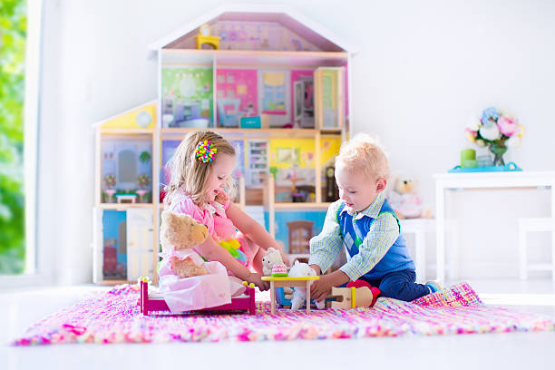 istock Kids playing with stuffed animals and doll house 486001172