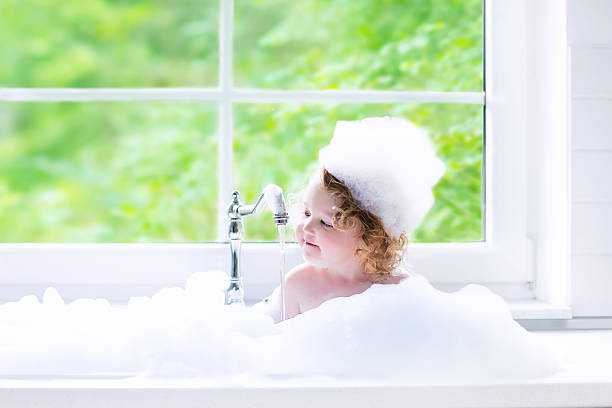 istock Baby girl taking bath with foam 486001176