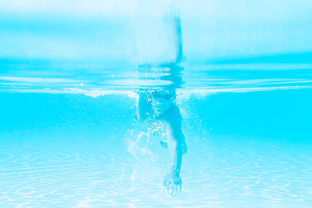 istock young man swimming the front crawl style in a pool 486001190