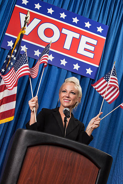 istock Female Politician waving American Flags 486002241