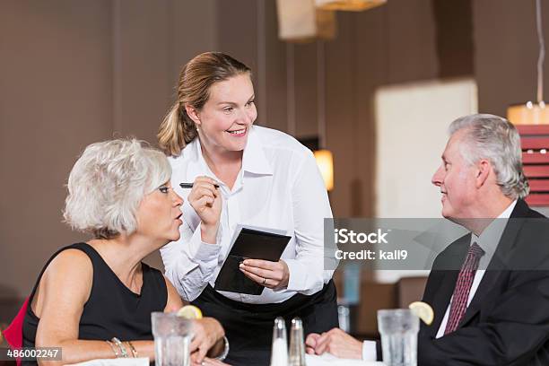 Waitress Taking Customer Orders Stock Photo - Download Image Now - 30-39 Years, 35-39 Years, 50-54 Years