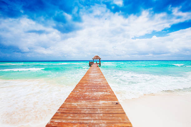 Tropical Beach with jetty. Mexico. Riviera Maya. Vacations and tourism concept: Caribbean Paradise. playa del carmen stock pictures, royalty-free photos & images