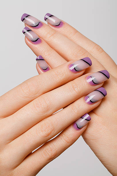 istock Beautiful woman hands with professional lilac nails 486002945