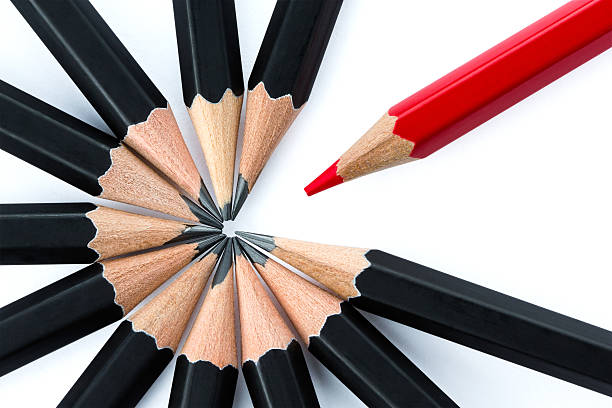 istock One red pencil opposite black pencils 486003439