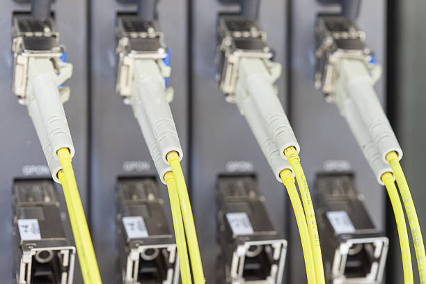 istock Yellow optic fiber connected to switch 486003753