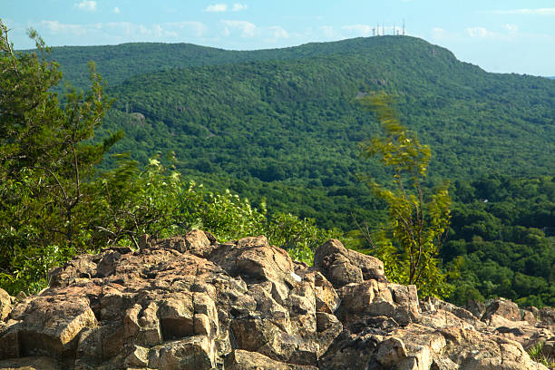istock Cliff on Ragged Mountain, with view of Hanging Hills, Connecticut. 486003876