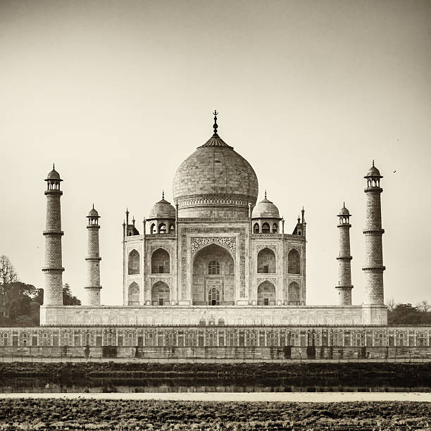 Taj Mahal in Black and White Famous Taj Mahal, the mausoleum located in Agra, India. It is one of the most recognizable structures in the world and is regarded as one of the eight wonders of the world. Black and White, Sepia toned image. Agra, India. india indian culture taj mahal temple stock pictures, royalty-free photos & images